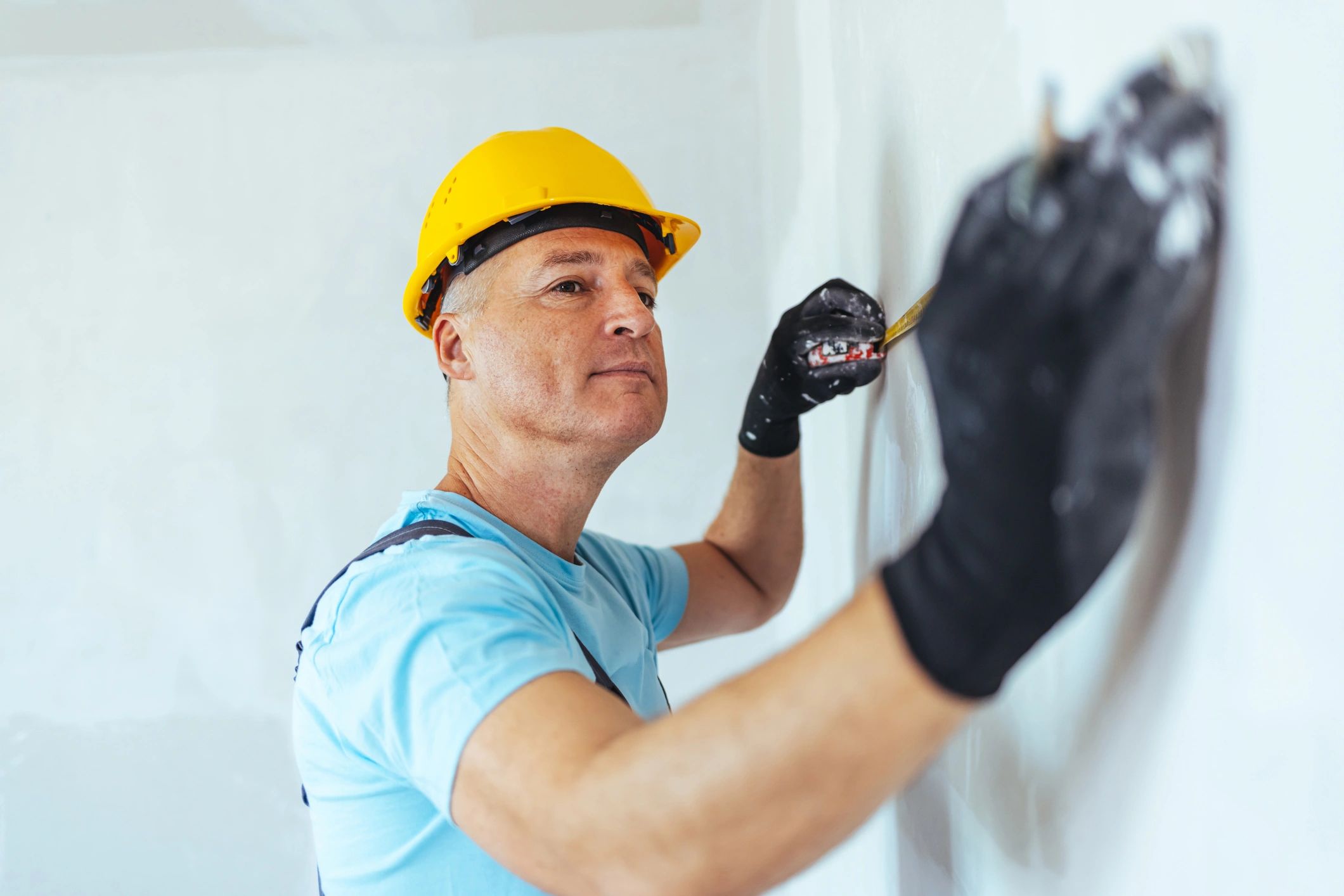 Contractor taking measurements during a home improvement project