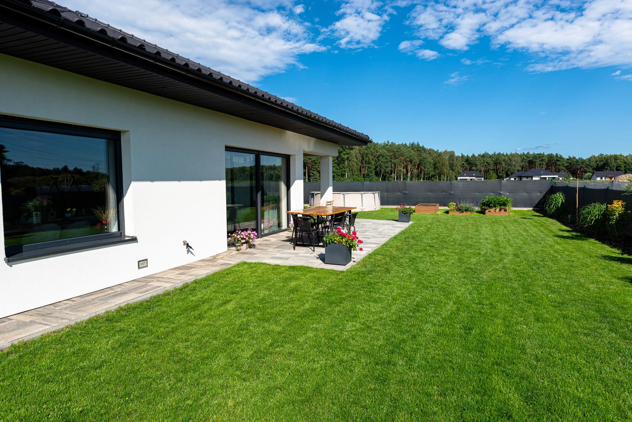 Residential home exterior with clean paved approach and landscaping
