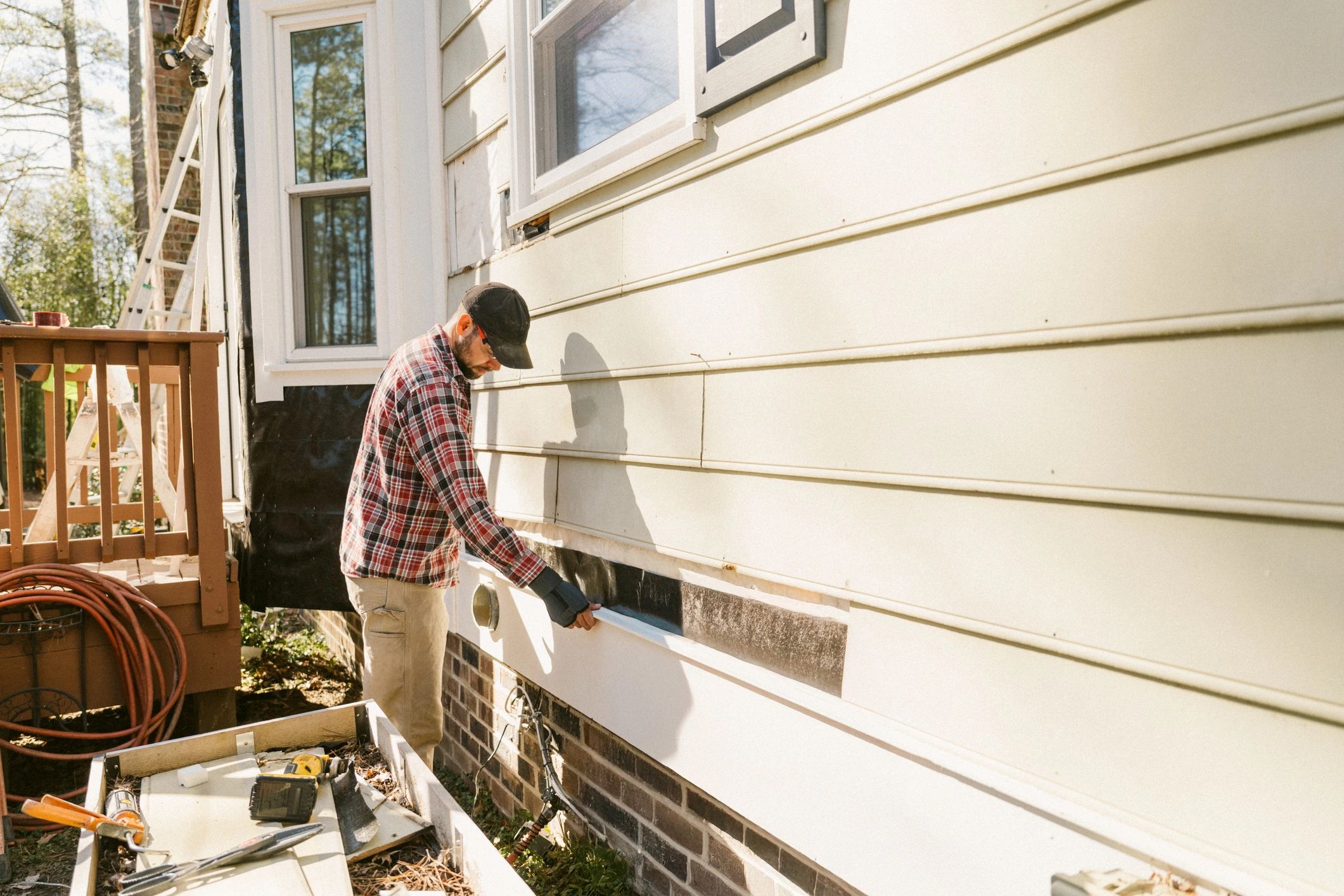 Construction worker repairing house exterior
