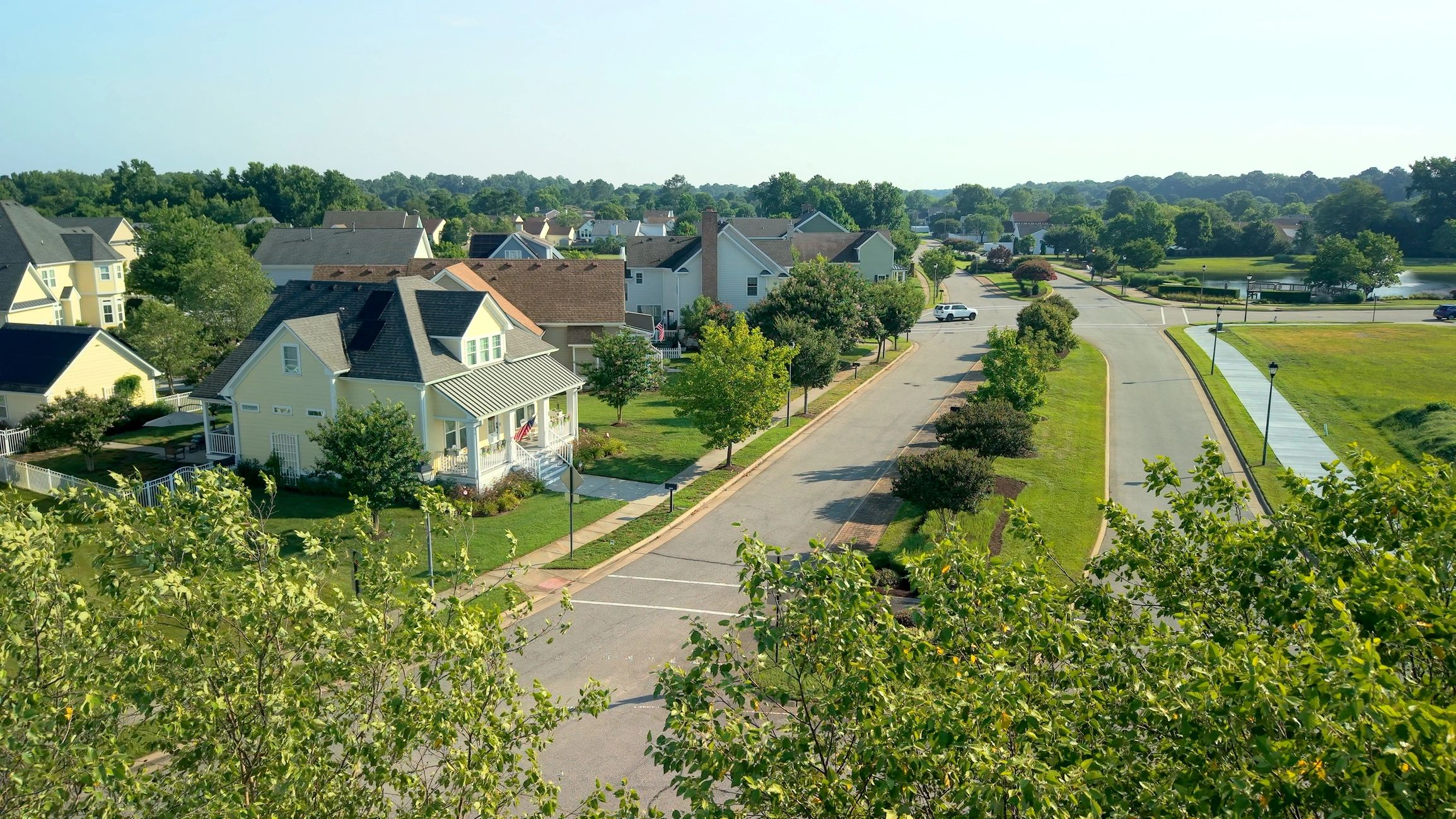 Neighborhood homes with broad paved frontage and drive access