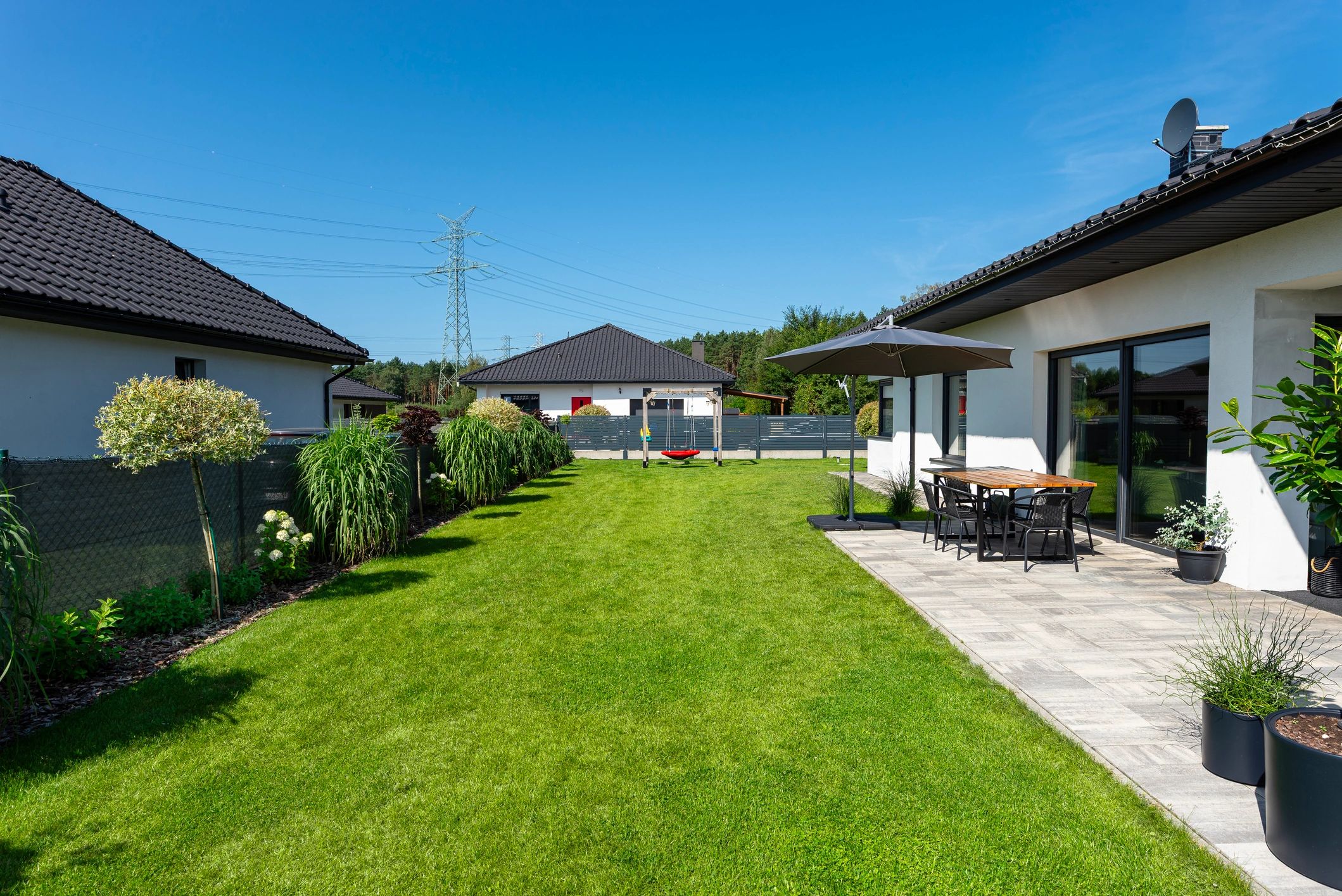 Backyard patio and deck area with umbrella