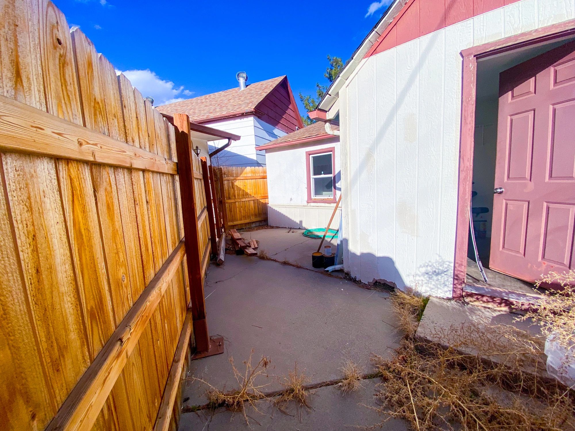 Residential exterior improvement area with walkway and fencing